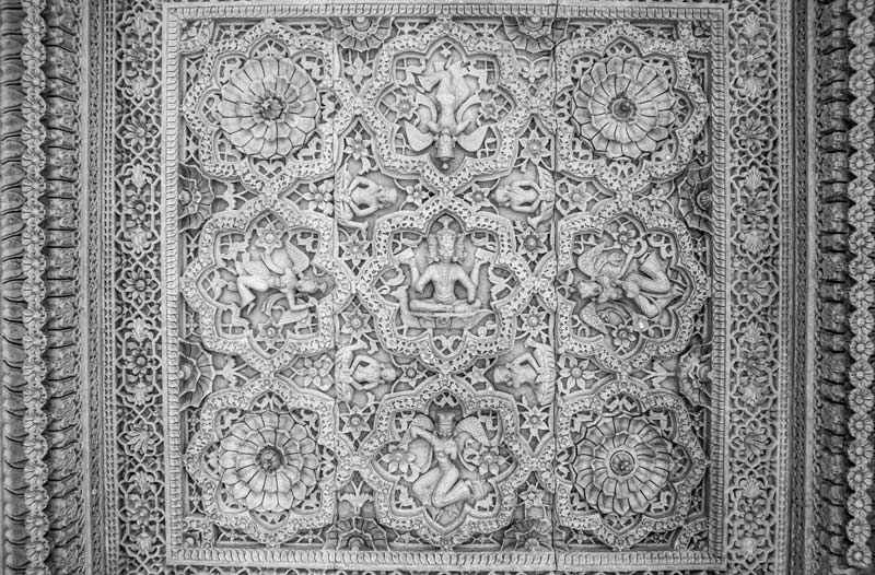 A ceiling panel inside a pavilion engraved with figures of Lord Brahma and multiple celestial beings, placed amidst floral designs on Rajsamand embankment